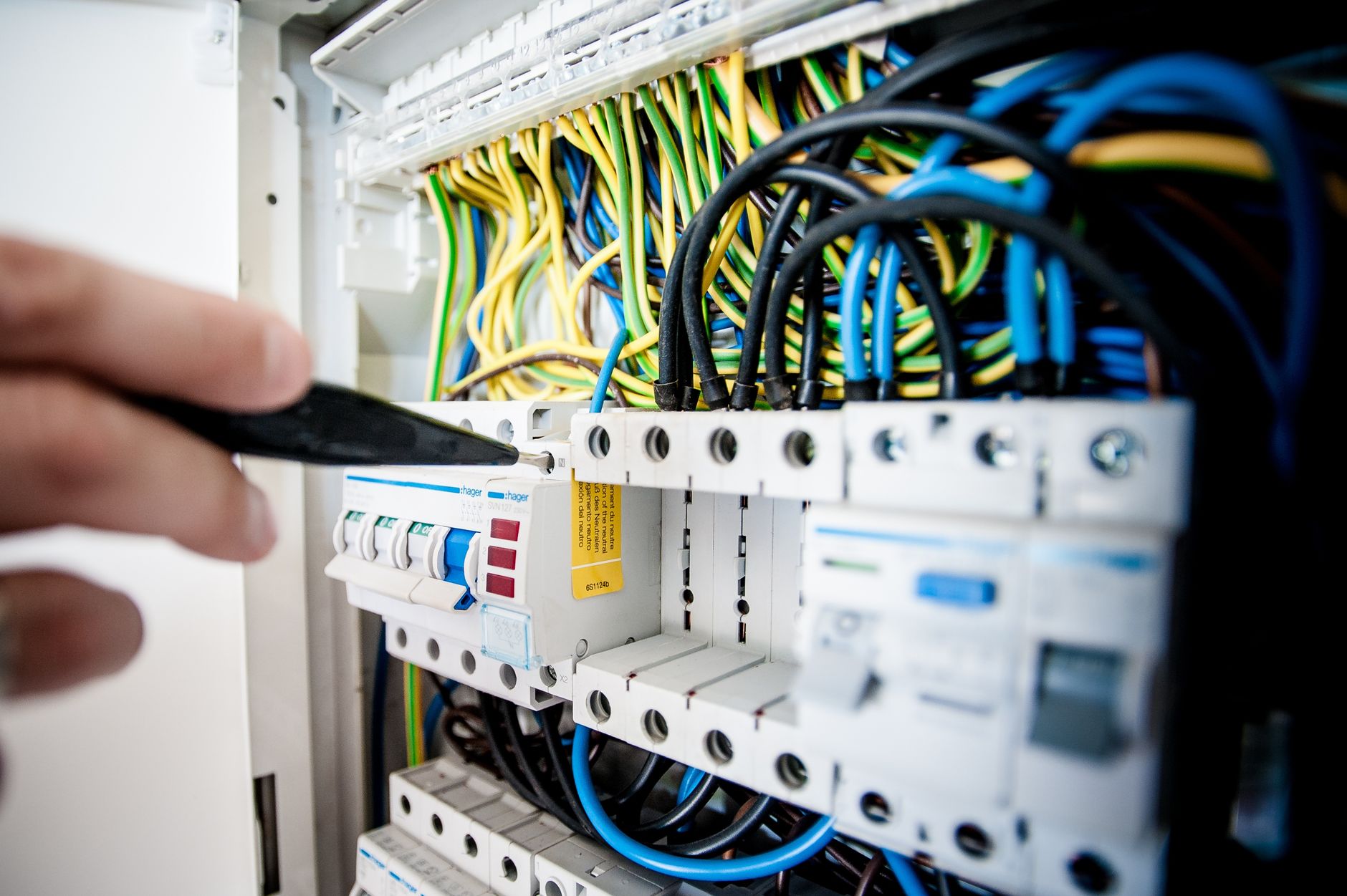 Electrician working inside an electrical panel